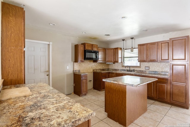4503 Tropical, San Antonio, TX 78218 - kitchen featuring black microwave, a sink, backsplash, brown cabinets, and recessed lighting
