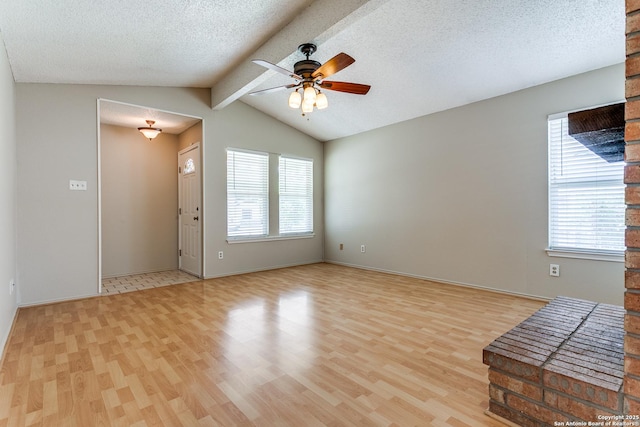 12215 Ridge Smt, San Antonio, TX 78247 - unfurnished living room featuring healthy amount of natural light, light wood finished floors, ceiling fan, a textured ceiling, and baseboards