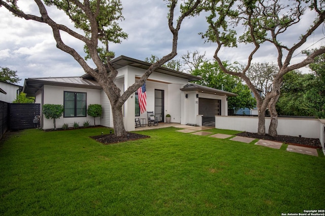 312 Frey, Boerne, TX 78006 - view of front of house featuring a standing seam roof, a garage, stucco siding, metal roof, and a patio