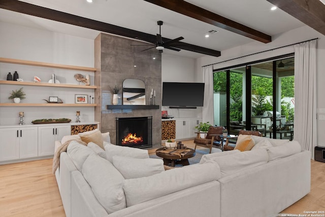 312 Frey, Boerne, TX 78006 - living area featuring beamed ceiling, light wood-style flooring, ceiling fan, and a fireplace