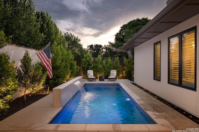 312 Frey, Boerne, TX 78006 - pool at dusk with a patio area and a fenced backyard