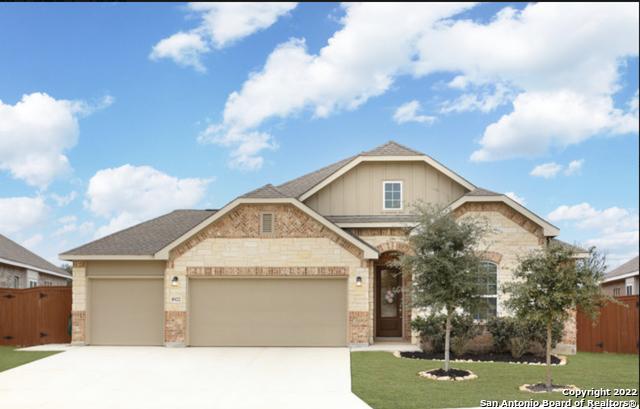 8922 Trail Dust, San Antonio, TX 78254 - view of front facade featuring an attached garage, driveway, brick siding, and stone siding