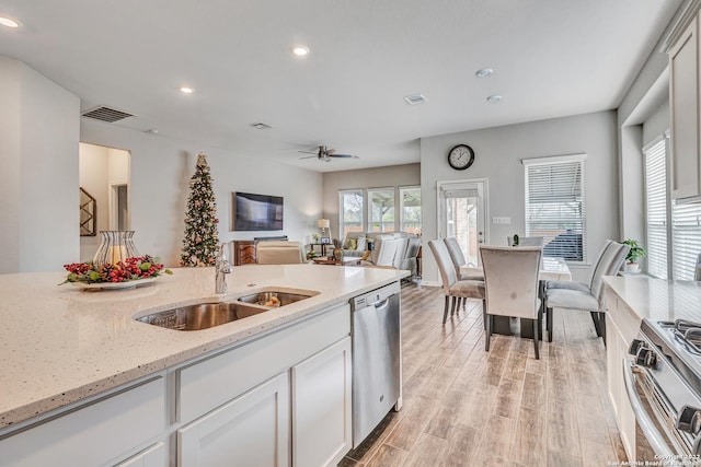 8922 Trail Dust, San Antonio, TX 78254 - kitchen with stainless steel appliances, a sink, recessed lighting, light wood-style floors, and open floor plan