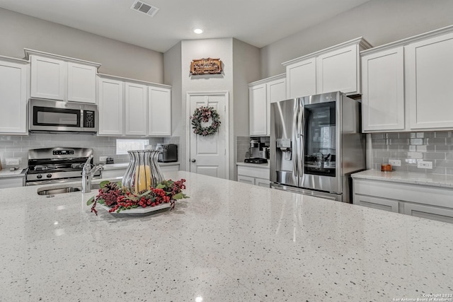 8922 Trail Dust, San Antonio, TX 78254 - kitchen featuring stainless steel appliances, decorative backsplash, white cabinetry, and recessed lighting