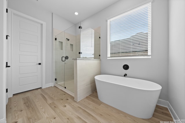 190 Azalea Aly, Castroville, TX 78009 - bathroom featuring a freestanding tub, wood finished floors, and a shower stall