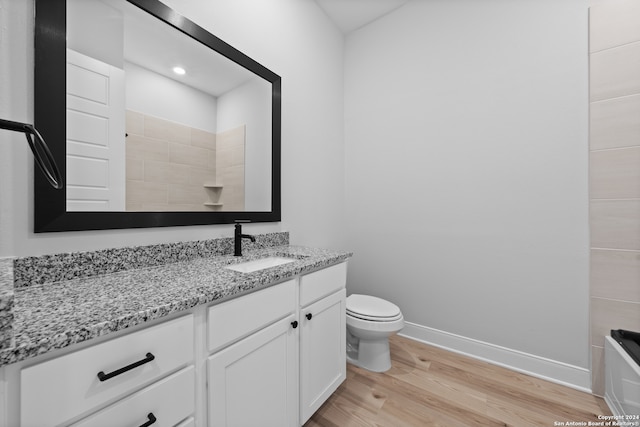 190 Azalea Aly, Castroville, TX 78009 - bathroom with vanity, wood finished floors, toilet, baseboards, and a tile shower