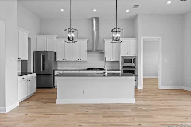 190 Azalea Aly, Castroville, TX 78009 - kitchen with appliances with stainless steel finishes, wall chimney range hood, dark countertops, a sink, and white cabinets
