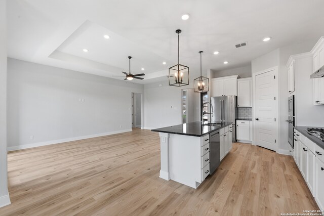 204 Azalea Aly, Castroville, TX 78009 - kitchen featuring dark countertops, light wood-style floors, ceiling fan, a sink, and recessed lighting