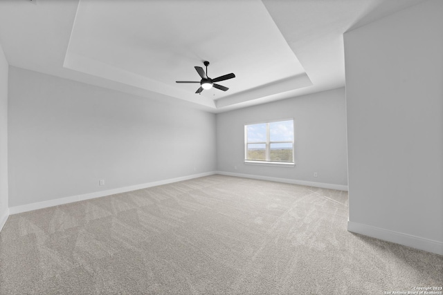 174 Azalea Aly, Castroville, TX 78009 - spare room with a raised ceiling, carpet flooring, baseboards, and ceiling fan
