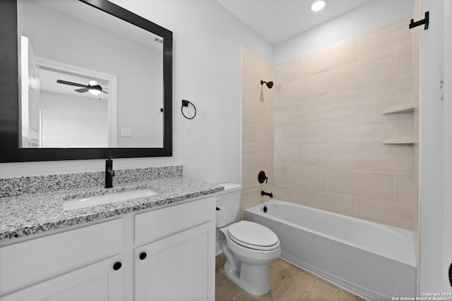 174 Azalea Aly, Castroville, TX 78009 - full bath featuring vanity, toilet, wood finished floors, washtub / shower combination, and a ceiling fan