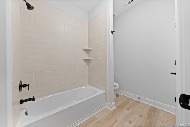 174 Azalea Aly, Castroville, TX 78009 - full bathroom with wood finished floors, toilet, bathtub / shower combination, and baseboards
