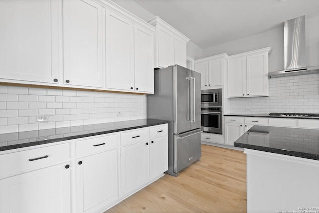 159 Azalea Aly, Castroville, TX 78009 - kitchen with appliances with stainless steel finishes, wall chimney exhaust hood, light wood-style floors, and white cabinetry