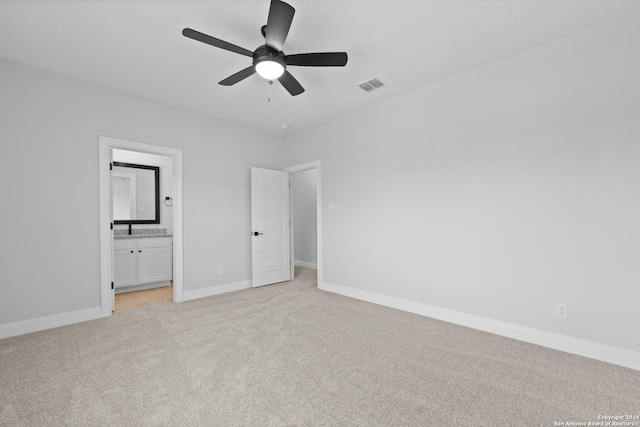 159 Azalea Aly, Castroville, TX 78009 - unfurnished bedroom featuring light carpet, baseboards, ensuite bathroom, and a ceiling fan