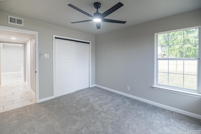 206 Scott, Universal City, TX 78148 - unfurnished bedroom featuring carpet, multiple windows, a closet, and baseboards