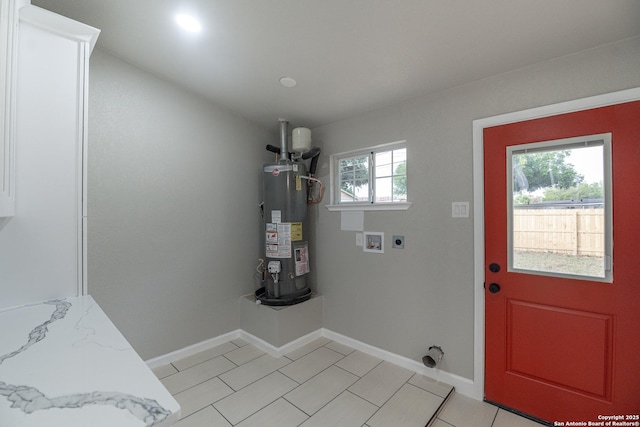 206 Scott, Universal City, TX 78148 - laundry area with gas water heater, hookup for an electric dryer, hookup for a washing machine, baseboards, and light tile patterned floors