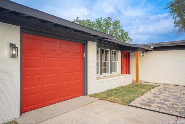206 Scott, Universal City, TX 78148 - entrance to property featuring brick siding, a garage, and concrete driveway