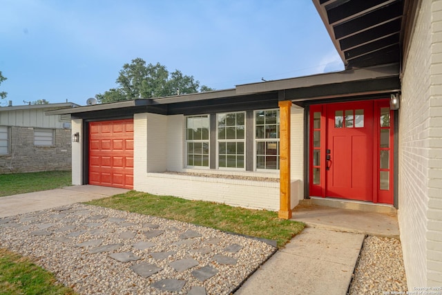 206 Scott, Universal City, TX 78148 - entrance to property featuring brick siding, concrete driveway, and a garage