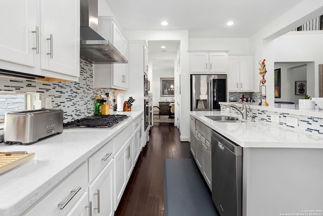 17 Denbury, San Antonio, TX 78257 - kitchen with wall chimney range hood, appliances with stainless steel finishes, a sink, tasteful backsplash, and white cabinetry