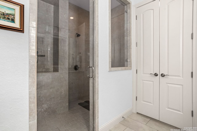 17 Denbury, San Antonio, TX 78257 - bathroom with a stall shower, tile patterned flooring, and baseboards