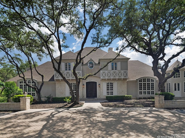 100 Tomahawk Hl, Country Village, TX 78232 - english style home featuring a shingled roof, stone siding, and a chimney