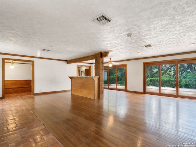 100 Tomahawk Hl, Country Village, TX 78232 - unfurnished living room featuring ceiling fan, a textured ceiling, baseboards, and crown molding