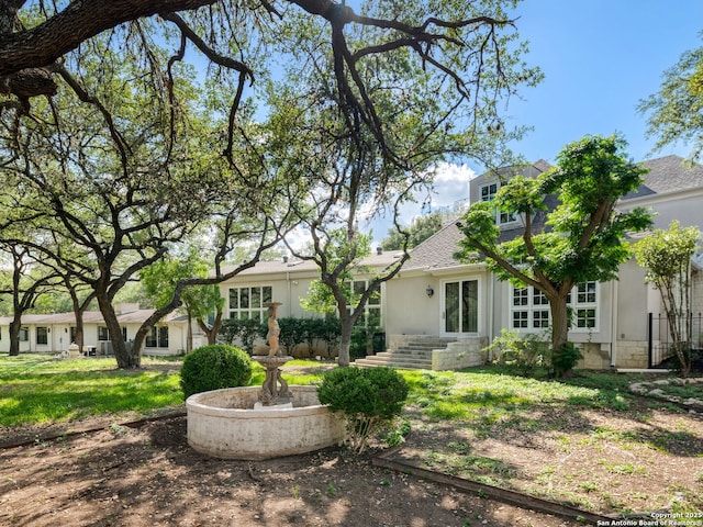 100 Tomahawk Hl, Country Village, TX 78232 - back of property featuring stucco siding, a shingled roof, and stone siding