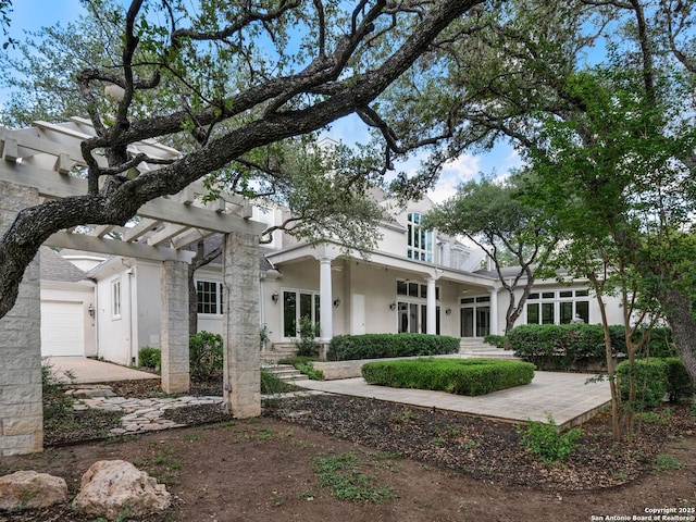 100 Tomahawk Hl, Country Village, TX 78232 - view of front facade featuring stucco siding and a pergola