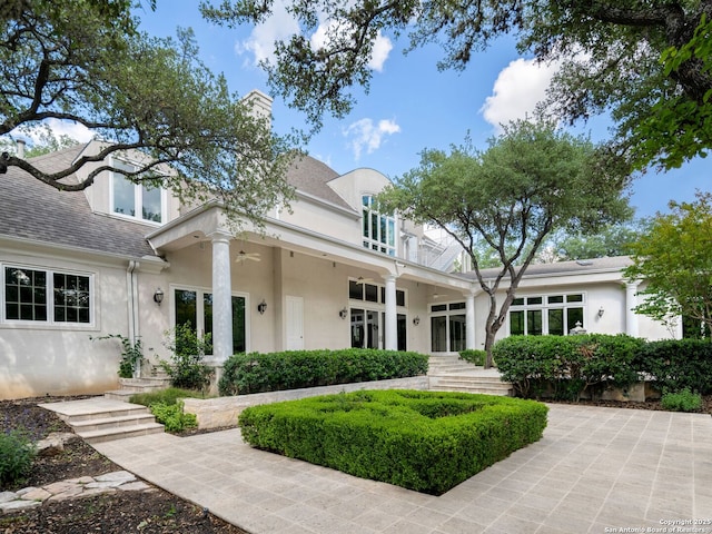 100 Tomahawk Hl, Country Village, TX 78232 - view of front facade featuring stucco siding, ceiling fan, and a chimney