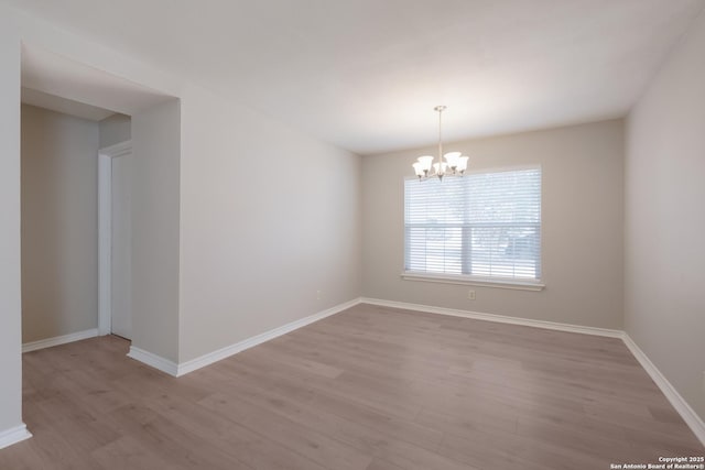 8314 Morning Grv, Converse, TX 78109 - empty room with light wood-type flooring, a chandelier, and baseboards