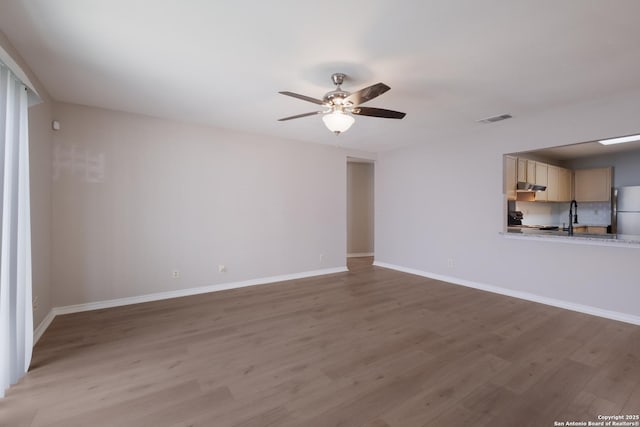 8314 Morning Grv, Converse, TX 78109 - unfurnished living room featuring wood finished floors, a ceiling fan, and baseboards