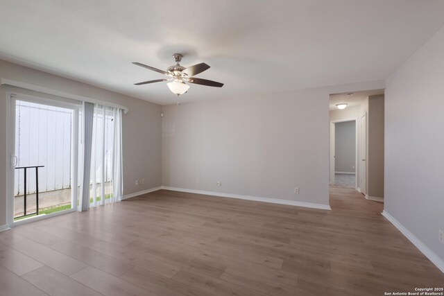 8314 Morning Grv, Converse, TX 78109 - unfurnished room with wood finished floors, a ceiling fan, and baseboards