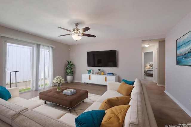 8314 Morning Grv, Converse, TX 78109 - living room featuring baseboards, healthy amount of natural light, a ceiling fan, and wood finished floors