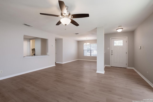 8314 Morning Grv, Converse, TX 78109 - entryway with ceiling fan, wood finished floors, a chandelier, and baseboards