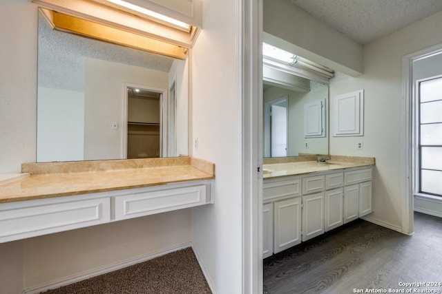 2514 Silver Rdg, San Antonio, TX 78232 - full bathroom with vanity, a textured ceiling, wood finished floors, and baseboards