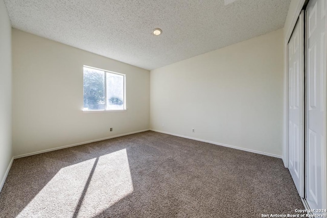 2514 Silver Rdg, San Antonio, TX 78232 - unfurnished bedroom with carpet, a textured ceiling, a closet, and baseboards