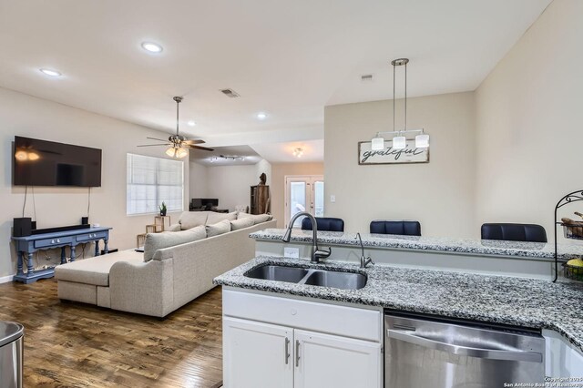 8010 Indian Bnd, San Antonio, TX 78250 - kitchen with dishwasher, a sink, a ceiling fan, white cabinets, and hanging light fixtures