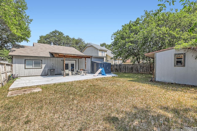 8010 Indian Bnd, San Antonio, TX 78250 - view of yard featuring a patio area, central AC unit, french doors, and an outdoor structure