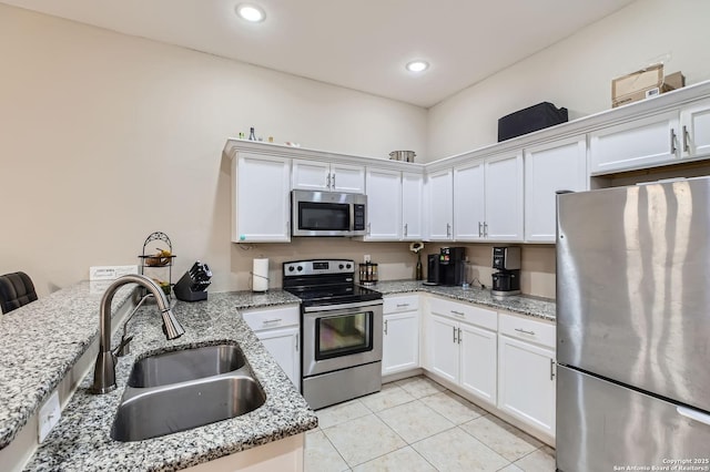 8010 Indian Bnd, San Antonio, TX 78250 - kitchen featuring stainless steel appliances, a sink, light tile patterned flooring, white cabinets, and recessed lighting