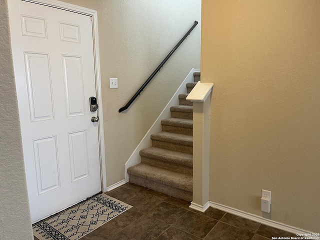 12242 Bening Vly, Schertz, TX 78154 - entryway with stairway, baseboards, and dark tile patterned flooring