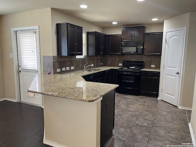 12242 Bening Vly, Schertz, TX 78154 - kitchen featuring black appliances, a sink, a peninsula, tasteful backsplash, and recessed lighting