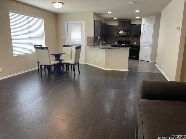 12242 Bening Vly, Schertz, TX 78154 - kitchen with black appliances, dark wood-type flooring, tasteful backsplash, baseboards, and recessed lighting