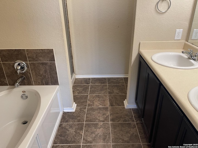 12242 Bening Vly, Schertz, TX 78154 - bathroom with double vanity, a garden tub, a textured wall, and a shower