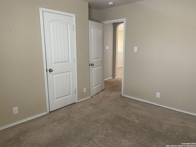 12242 Bening Vly, Schertz, TX 78154 - unfurnished bedroom with carpet floors, baseboards, and arched walkways