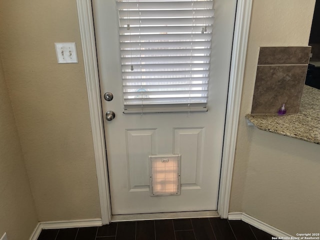 12242 Bening Vly, Schertz, TX 78154 - doorway to outside featuring baseboards