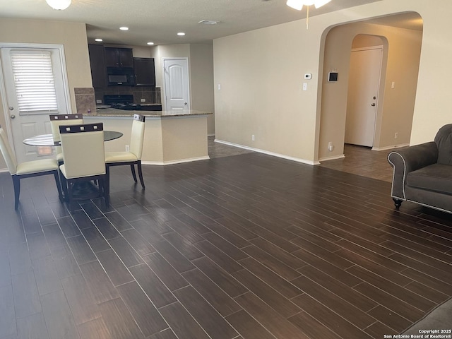 12242 Bening Vly, Schertz, TX 78154 - dining space featuring dark wood-type flooring, arched walkways, baseboards, a ceiling fan, and recessed lighting