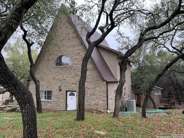 1076 Eastview, Canyon Lake, TX 78133 - view of side of home with brick siding and central air condition unit