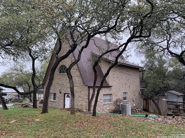 1076 Eastview, Canyon Lake, TX 78133 - view of side of property with central AC unit and brick siding