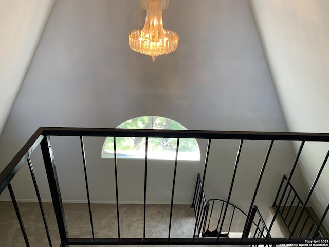 1076 Eastview, Canyon Lake, TX 78133 - staircase with a chandelier, carpet floors, baseboards, and a towering ceiling