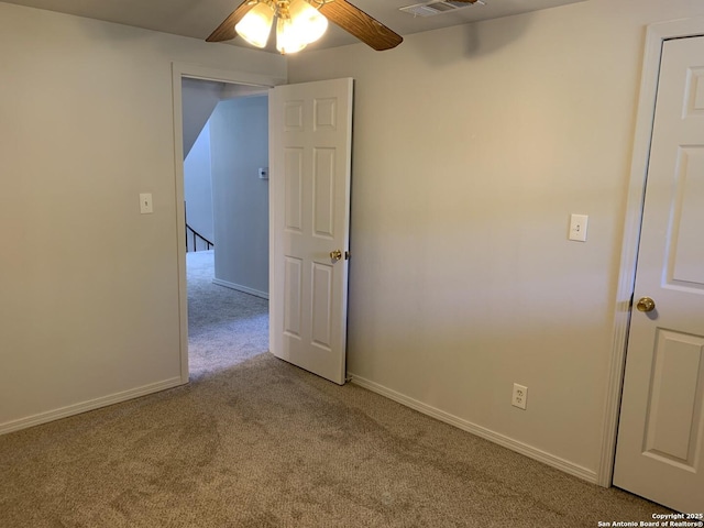 1076 Eastview, Canyon Lake, TX 78133 - spare room featuring carpet floors, a ceiling fan, and baseboards