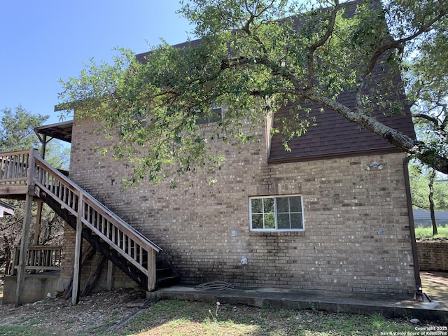 1076 Eastview, Canyon Lake, TX 78133 - view of property exterior featuring stairway and brick siding